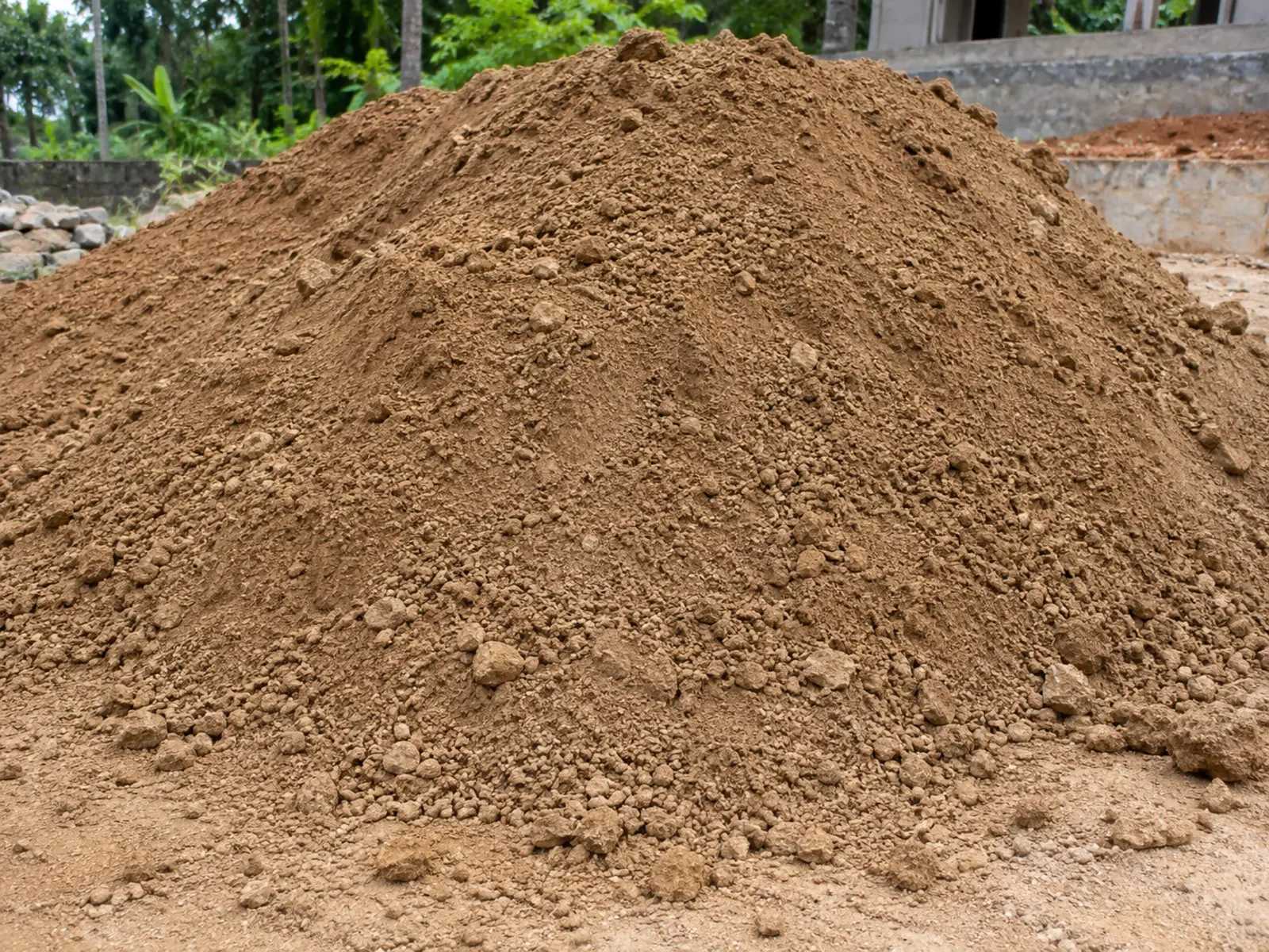 Natural soil stockpile with a realistic mixed granular texture at a residential construction site.